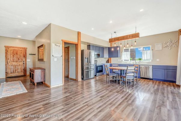 Dining room, Interior, Kitchen, Pendant Lights, Recessed Lighting, Stainless Steel Appliances, Wood Texture Flooring