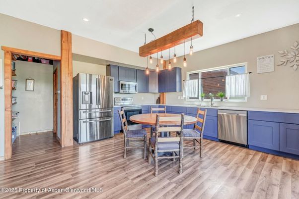 Dining room, Interior, Kitchen, Pendant Lights, Recessed Lighting, Stainless Steel Appliances, Wood Texture Flooring