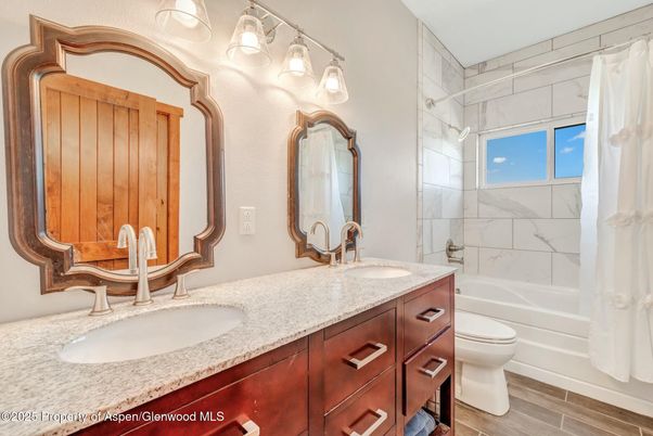 Bathroom, Dual Sink Vanities, Interior, Marble Walls, Wood Texture Flooring
