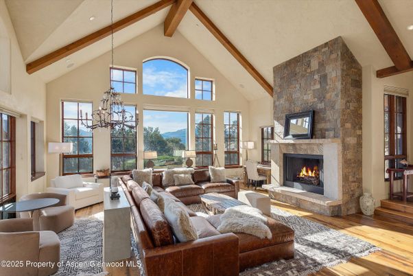 Chandelier, Fireplace, Interior, Living room, Recessed Lighting, Stone Walls, Wooden Beams, Wood Texture Flooring
