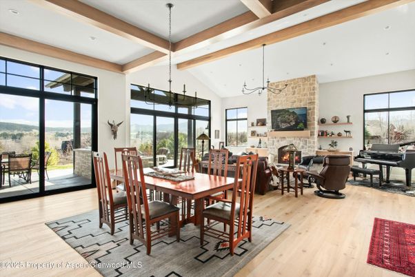 Dining room, Fireplace, Interior, Living room, Pendant Lights, Piano, Recessed Lighting, Stone Walls, Wooden Beams, Wood Texture Flooring