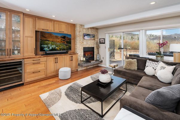 Fireplace, Interior, Living room, Recessed Lighting, Stone Walls, Wood Texture Flooring
