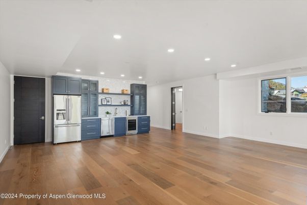 Empty room, Interior, Kitchen, Recessed Lighting, Stainless Steel Appliances, Wood Texture Flooring