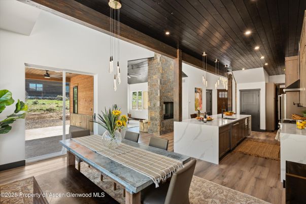 Dining room, Fireplace, Interior, Kitchen, Pendant Lights, Recessed Lighting, Stainless Steel Appliances, Wooden Ceilings, Wood Texture Flooring
