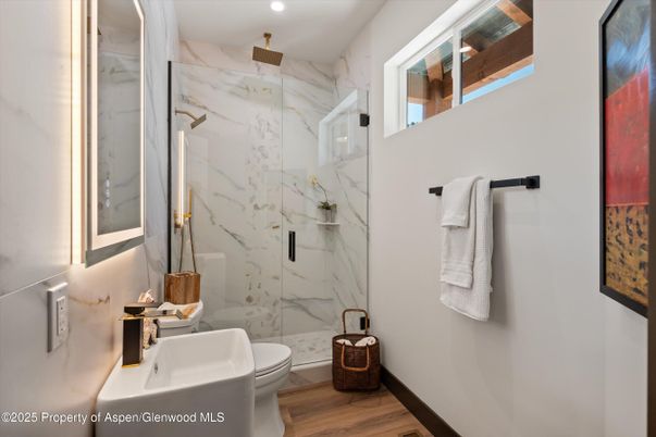 Bathroom, Glass Shower, Interior, Marble Walls, Recessed Lighting, Wood Texture Flooring