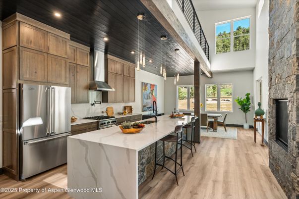 Dining room, Fireplace, Interior, Kitchen, Pendant Lights, Recessed Lighting, Stainless Steel Appliances, Wood Texture Flooring