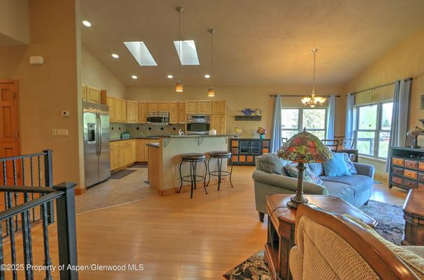 Chandelier, Dining room, Interior, Kitchen, Living room, Pendant Lights, Recessed Lighting, Stainless Steel Appliances, Wood Texture Flooring