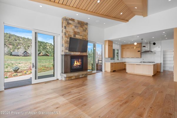Fireplace, Interior, Kitchen, Pendant Lights, Recessed Lighting, Stainless Steel Appliances, Wooden Ceilings, Wood Texture Flooring