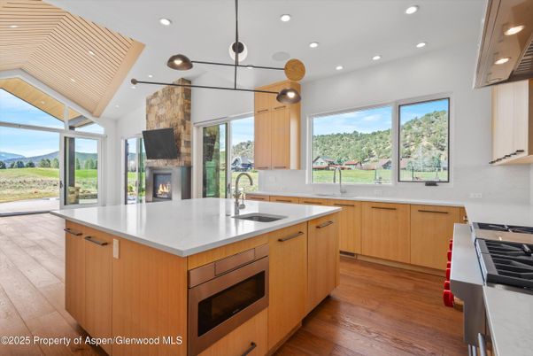 Fireplace, Interior, Kitchen, Pendant Lights, Recessed Lighting, Stainless Steel Appliances, Wood Texture Flooring