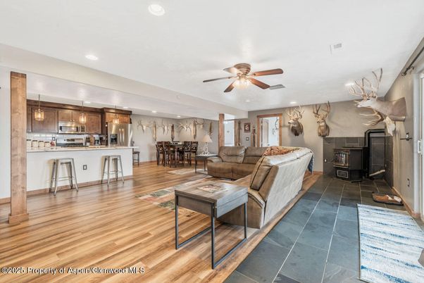 Dining room, Fireplace, Interior, Kitchen, Living room, Pendant Lights, Recessed Lighting, Stainless Steel Appliances, Wood Texture Flooring