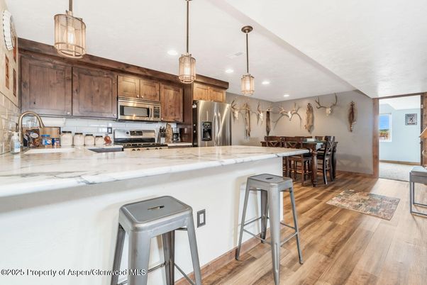 Dining room, Interior, Kitchen, Pendant Lights, Recessed Lighting, Stainless Steel Appliances, Wood Texture Flooring