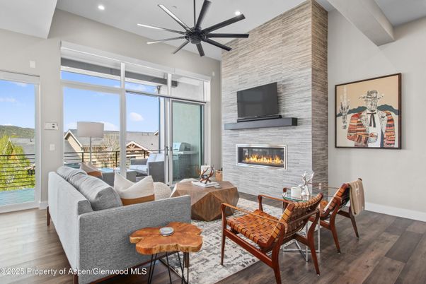 Dining room, Fireplace, Interior, Living room, Recessed Lighting, Stone Walls, Wood Texture Flooring