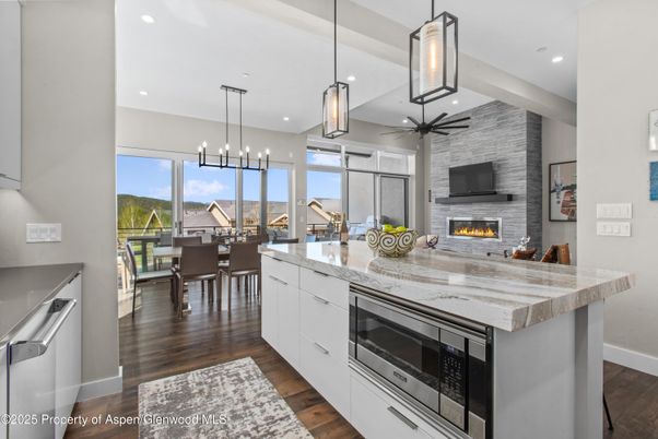 Dining room, Fireplace, Interior, Kitchen, Pendant Lights, Recessed Lighting, Stainless Steel Appliances, Stone Walls, Wood Texture Flooring
