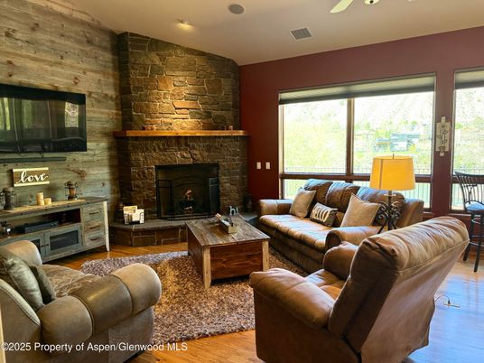 Fireplace, Interior, Living room, Recessed Lighting, Stone Walls, Wood Texture Flooring