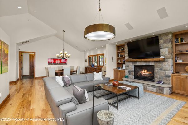 Chandelier, Dining room, Fireplace, Interior, Living room, Pendant Lights, Recessed Lighting, Wood Texture Flooring