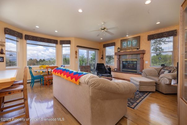 Dining room, Fireplace, Interior, Living room, Recessed Lighting, Wood Texture Flooring