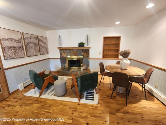 Dining room, Fireplace, Interior, Living room, Recessed Lighting, Wood Texture Flooring