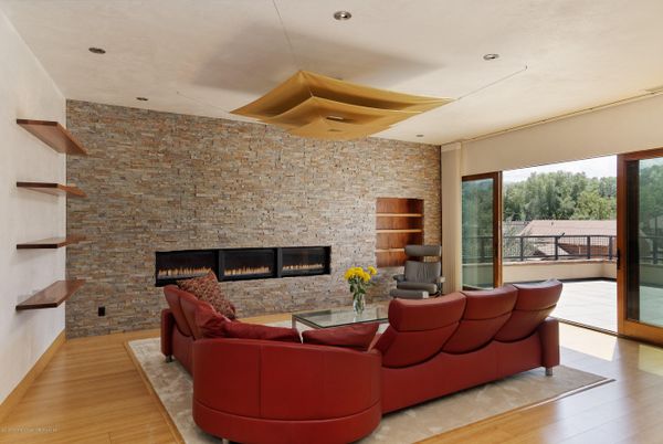 Fireplace, Interior, Living room, Recessed Lighting, Stone Walls, Wood Texture Flooring