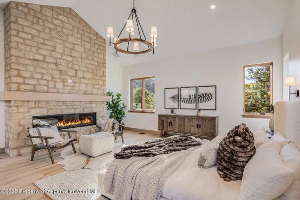 Bedroom, Chandelier, Fireplace, Interior, Living room, Pendant Lights, Recessed Lighting, Stone Walls, Wood Texture Flooring
