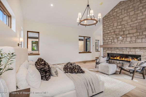 Chandelier, Fireplace, Interior, Living room, Pendant Lights, Recessed Lighting, Stone Walls, Wood Texture Flooring