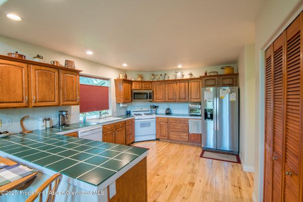 Interior, Kitchen, Recessed Lighting, Stainless Steel Appliances, Tile Countertops, Wood Texture Flooring