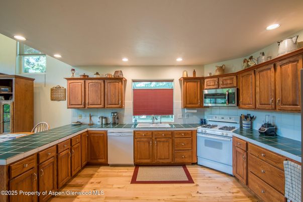 Interior, Kitchen, Recessed Lighting, Tile Countertops, Wood Texture Flooring