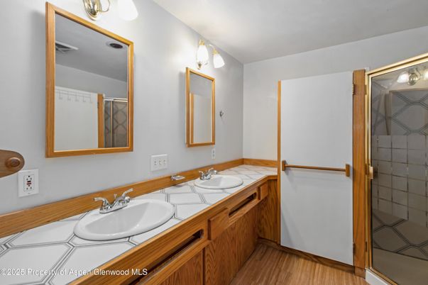 Bathroom, Dual Sink Vanities, Glass Shower, Interior, Tile Countertops, Wood Texture Flooring