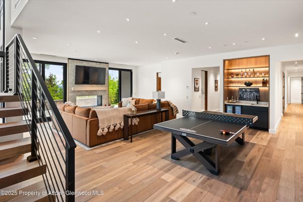 Fireplace, Game Room, Interior, Living room, Recessed Lighting, Wood Texture Flooring