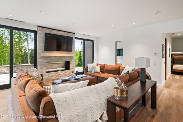 Fireplace, Interior, Living room, Recessed Lighting, Stone Walls, Wood Texture Flooring