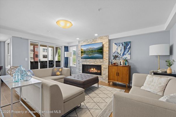Fireplace, Interior, Living room, Recessed Lighting, Stone Walls, Wood Texture Flooring