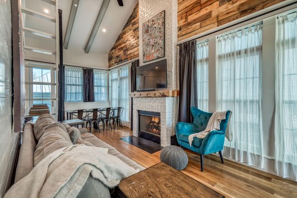 Dining room, Fireplace, Interior, Living room, Recessed Lighting, Stone Walls, Wood Texture Flooring