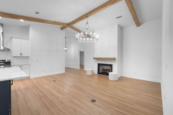 Empty room, Fireplace, Interior, Kitchen, Pendant Lights, Recessed Lighting, Wooden Beams, Wood Texture Flooring