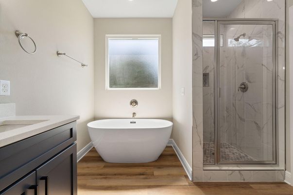 Bathroom, Free Standing Baths, Glass Shower, Interior, Marble Walls, Recessed Lighting, Wood Texture Flooring