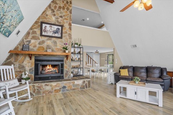 Dining room, Fireplace, Interior, Living room, Recessed Lighting, Stone Walls, Wood Texture Flooring