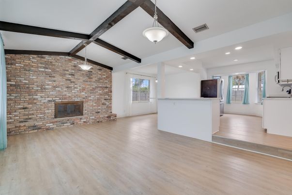 Empty room, Fireplace, Interior, Pendant Lights, Recessed Lighting, Stone Walls, Wooden Beams, Wood Texture Flooring