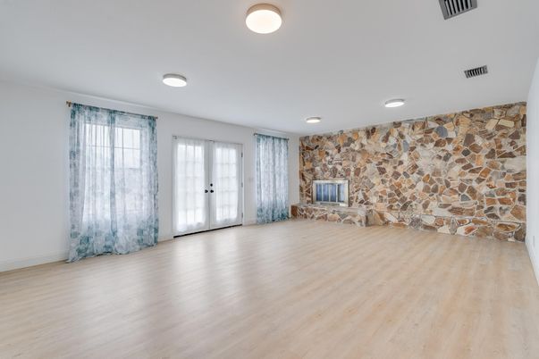Empty room, Fireplace, Interior, Recessed Lighting, Stone Walls, Wood Texture Flooring
