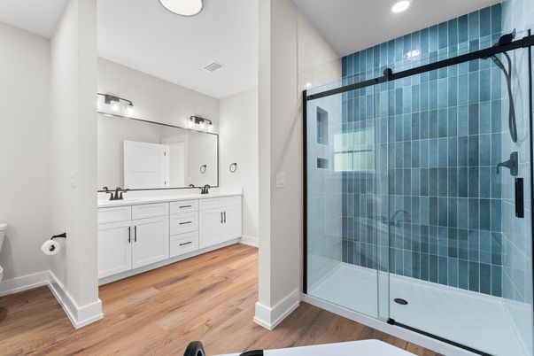 Bathroom, Dual Sink Vanities, Glass Shower, Interior, Recessed Lighting, Wood Texture Flooring