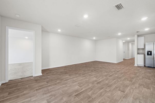 Empty room, Interior, Kitchen, Recessed Lighting, Stainless Steel Appliances, Wood Texture Flooring