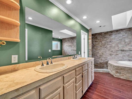 Bathroom, Dual Sink Vanities, Interior, Recessed Lighting, Stone Walls, Tile Countertops, Wood Texture Flooring