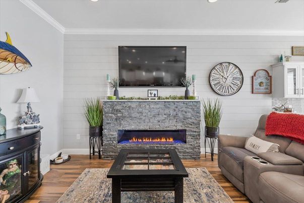 Fireplace, Interior, Living room, Recessed Lighting, Stone Walls, Wood Texture Flooring