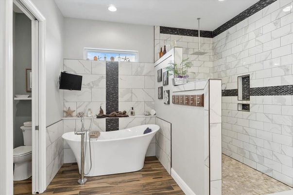 Bathroom, Free Standing Baths, Interior, Marble Walls, Recessed Lighting, Wood Texture Flooring