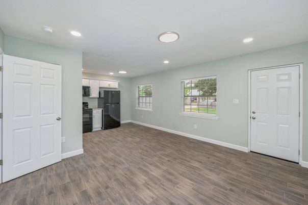 Empty room, Interior, Kitchen, Recessed Lighting, Stainless Steel Appliances, Wood Texture Flooring