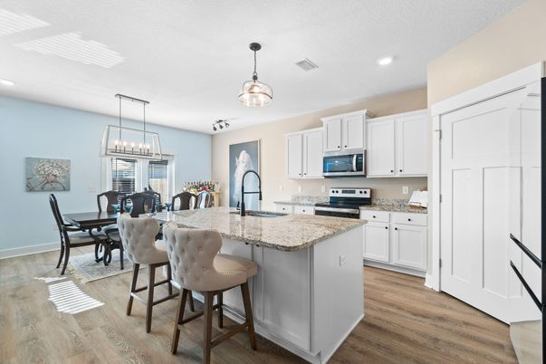 Chandelier, Dining room, Interior, Kitchen, Pendant Lights, Recessed Lighting, Stainless Steel Appliances, Wood Texture Flooring