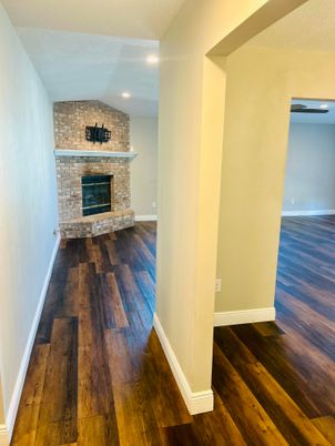 Empty room, Fireplace, Interior, Recessed Lighting, Stone Walls, Wood Texture Flooring