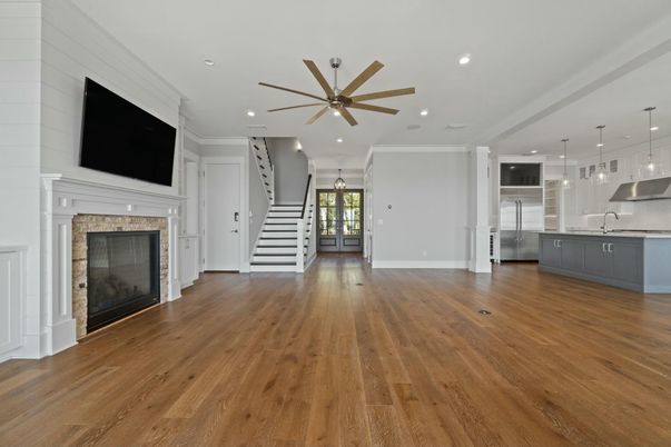 Empty room, Fireplace, Interior, Kitchen, Pendant Lights, Recessed Lighting, Stainless Steel Appliances, Wood Texture Flooring