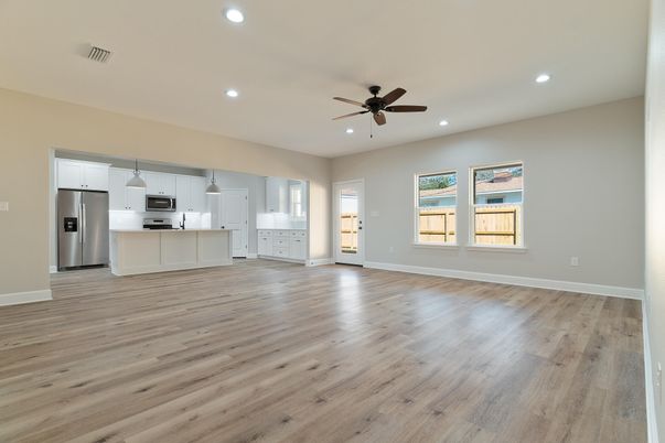 Empty room, Interior, Kitchen, Recessed Lighting, Stainless Steel Appliances, Wood Texture Flooring