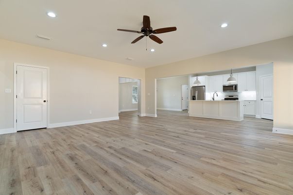 Empty room, Interior, Kitchen, Recessed Lighting, Stainless Steel Appliances, Wood Texture Flooring