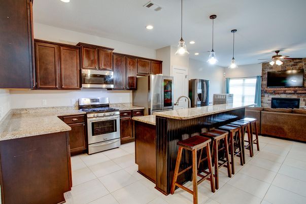 Fireplace, Interior, Kitchen, Living room, Pendant Lights, Recessed Lighting, Stainless Steel Appliances, Stone Walls