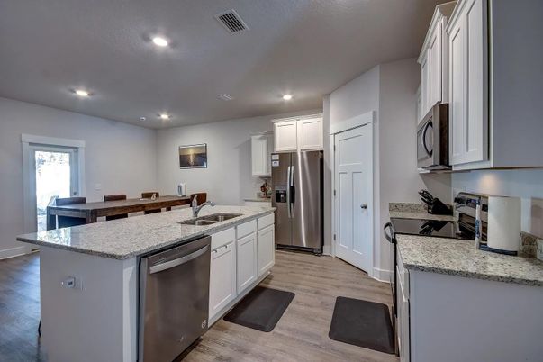 Dining room, Interior, Kitchen, Recessed Lighting, Stainless Steel Appliances, Wood Texture Flooring