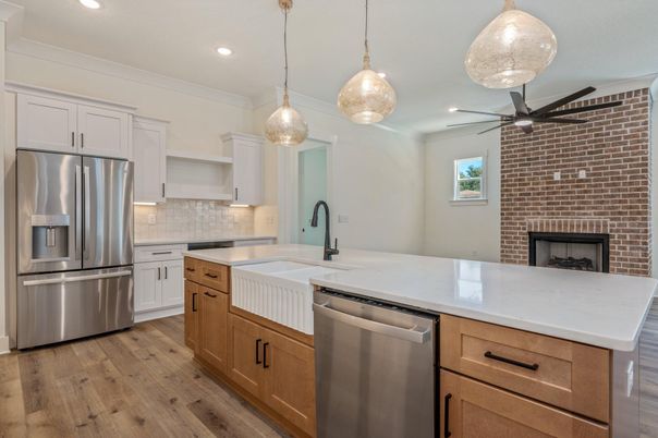 Fireplace, Interior, Kitchen, Pendant Lights, Recessed Lighting, Stainless Steel Appliances, Stone Walls, Wood Texture Flooring